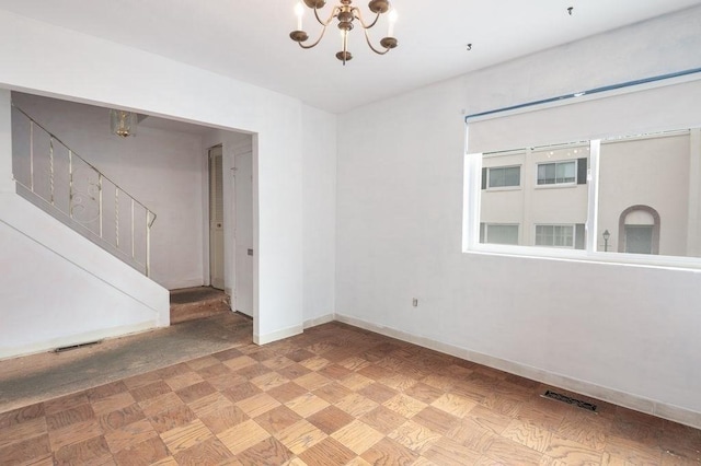 1 Charles St Unit W, Reading, MA 01867 - spare room with a chandelier, stairs, and baseboards