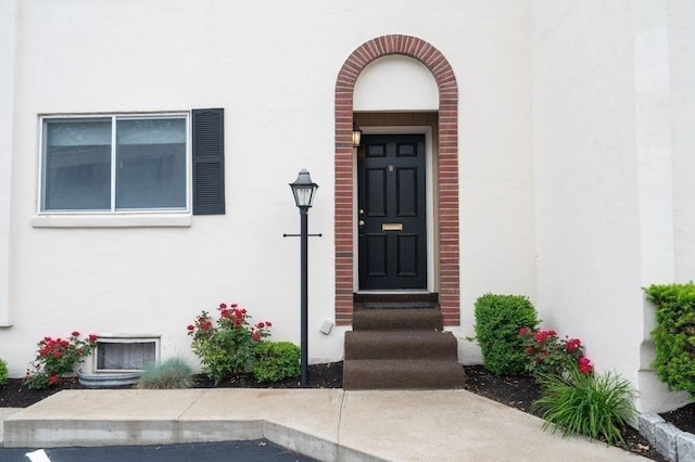 1 Charles St Unit W, Reading, MA 01867 - view of exterior entry featuring stucco siding