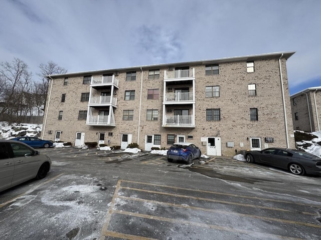 view of building exterior featuring uncovered parking