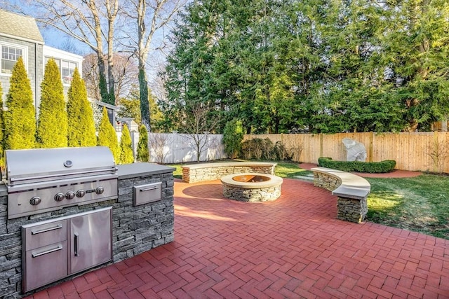 view of patio with area for grilling and an outdoor fire pit