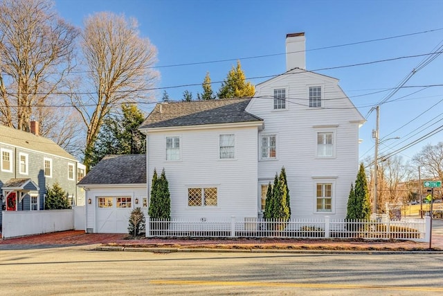 rear view of house with a garage