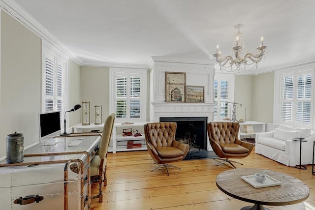 sitting room featuring crown molding, a fireplace, a chandelier, and light wood-type flooring