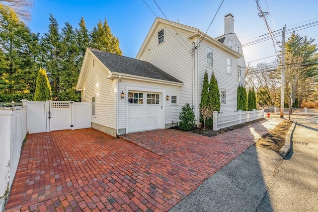 view of side of home featuring a garage