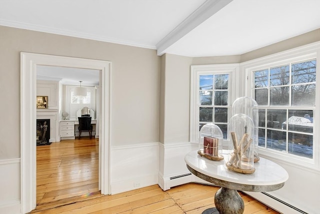 dining room with crown molding, hardwood / wood-style floors, and baseboard heating