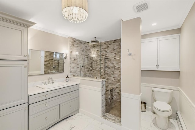 bathroom with toilet, a tile shower, baseboard heating, ornamental molding, and vanity