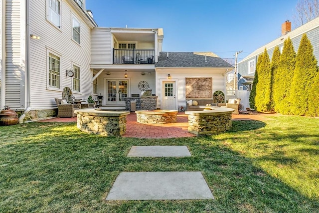 back of house with a patio, a balcony, and a yard