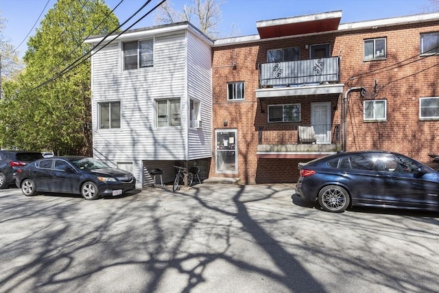 back of house featuring brick siding