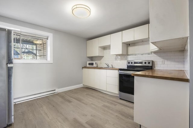 kitchen with stainless steel range with electric cooktop, baseboard heating, wooden counters, light wood-style flooring, and white cabinetry