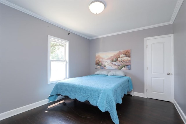 bedroom featuring crown molding and dark wood-type flooring