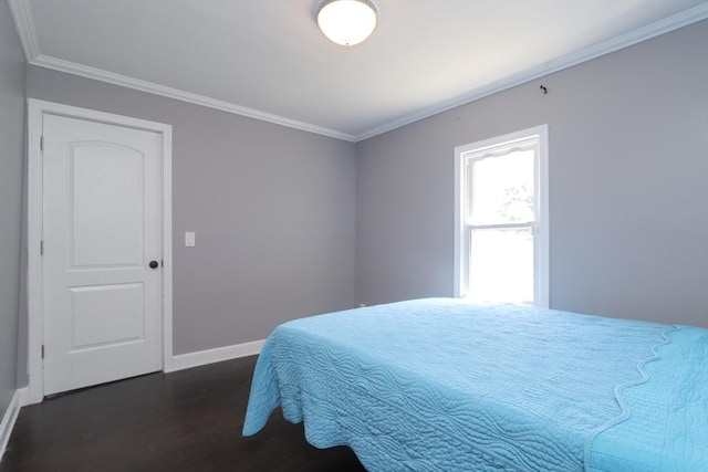 bedroom with dark wood-type flooring and ornamental molding