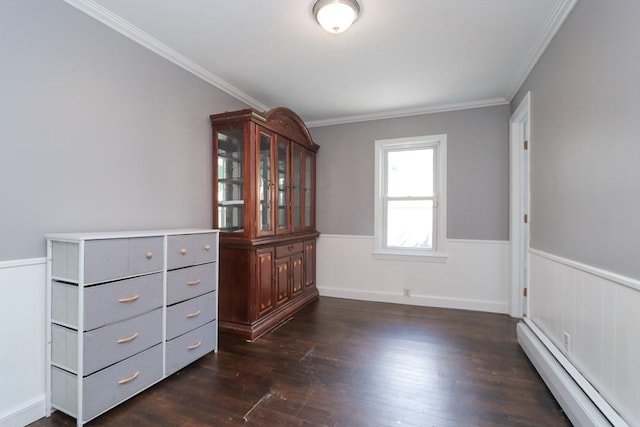 empty room with dark hardwood / wood-style flooring, a baseboard radiator, and ornamental molding