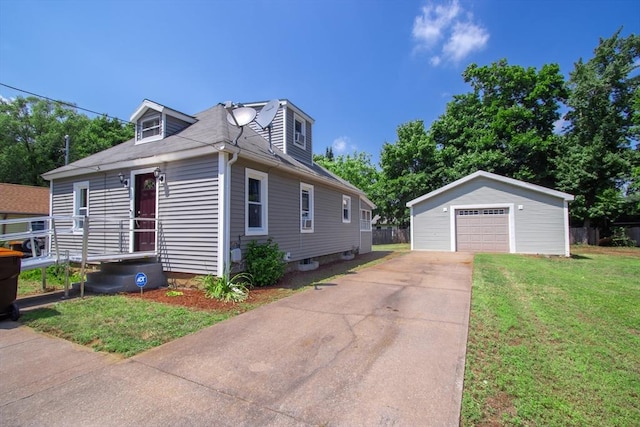 view of front of home with an outbuilding, a front yard, and a garage