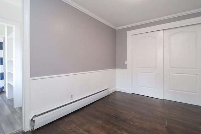 unfurnished bedroom with dark hardwood / wood-style flooring, a baseboard radiator, a closet, and crown molding