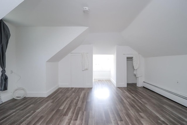 bonus room featuring dark hardwood / wood-style flooring, a baseboard radiator, and lofted ceiling