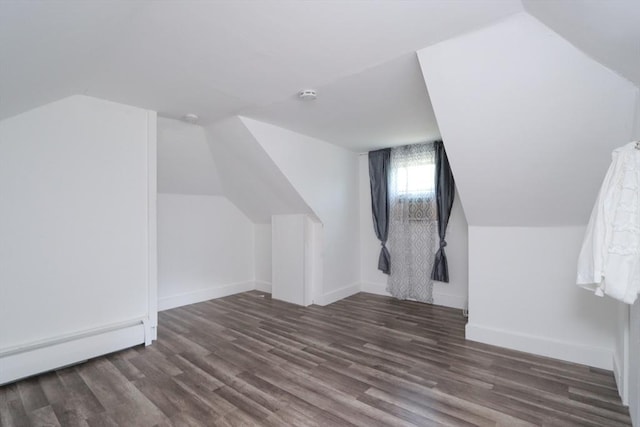 bonus room featuring dark hardwood / wood-style floors, lofted ceiling, and baseboard heating