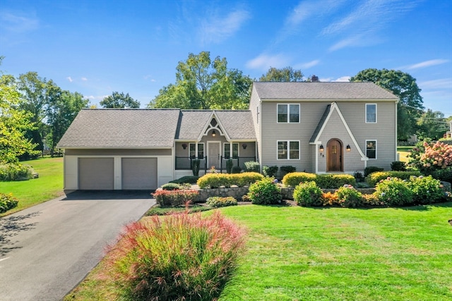 view of front of property with a garage and a front lawn