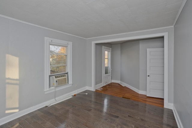 spare room featuring crown molding, cooling unit, and dark wood-type flooring