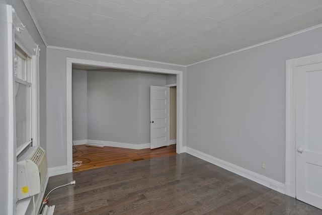 unfurnished bedroom with dark hardwood / wood-style flooring, a closet, and ornamental molding