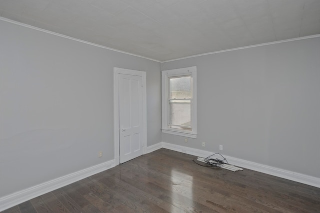 empty room with dark hardwood / wood-style flooring and ornamental molding