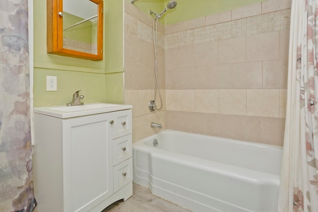 bathroom with vanity, wood-type flooring, and shower / bath combo