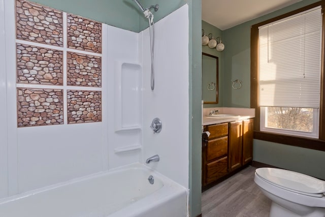 full bathroom featuring vanity,  shower combination, hardwood / wood-style flooring, and toilet