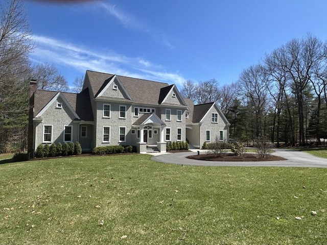 view of front of home with a front lawn and a chimney