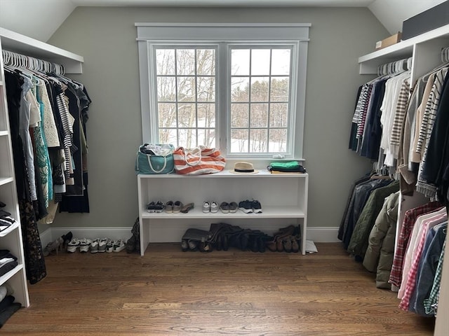 spacious closet featuring wood finished floors and vaulted ceiling