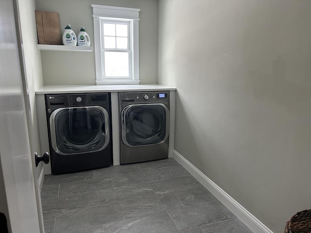 laundry room with separate washer and dryer, laundry area, and baseboards