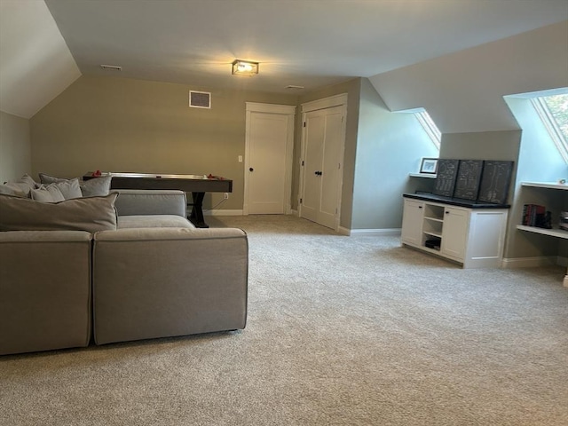 living room with visible vents, baseboards, vaulted ceiling, and light carpet