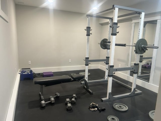 workout room featuring baseboards
