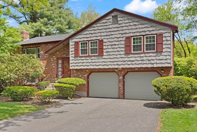 view of front of house featuring a garage, driveway, and brick siding