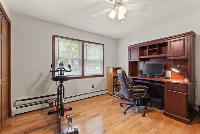 office space with baseboard heating, ceiling fan, and light wood-type flooring
