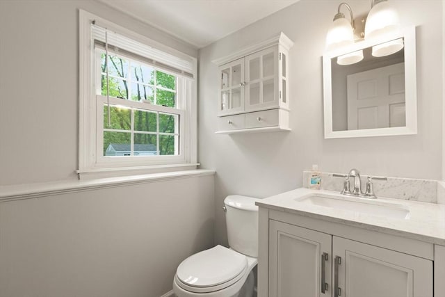 half bathroom featuring toilet and vanity