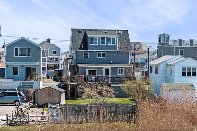 67 N End Blvd Unit 1, Salisbury, MA 01952 - back of property featuring stairs, a residential view, a shingled roof, and a deck