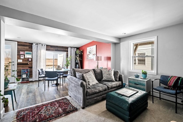 67 N End Blvd Unit 1, Salisbury, MA 01952 - living room featuring plenty of natural light, wood walls, baseboard heating, and wood finished floors