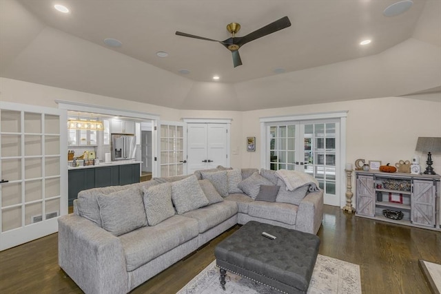 living room with ceiling fan, dark hardwood / wood-style flooring, lofted ceiling, and french doors