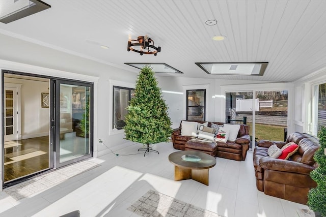 sunroom featuring wooden ceiling and a skylight