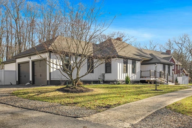 view of side of property with a yard and a garage