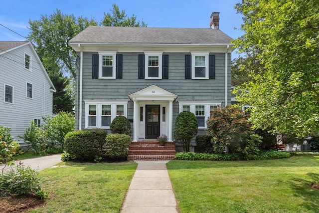 32 Oneida Rd, Winchester, MA 01890 - colonial home featuring a chimney, a front lawn, and roof with shingles