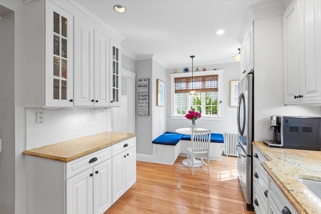 32 Oneida Rd, Winchester, MA 01890 - kitchen with white cabinets, light wood-style floors, tasteful backsplash, ornamental molding, and recessed lighting