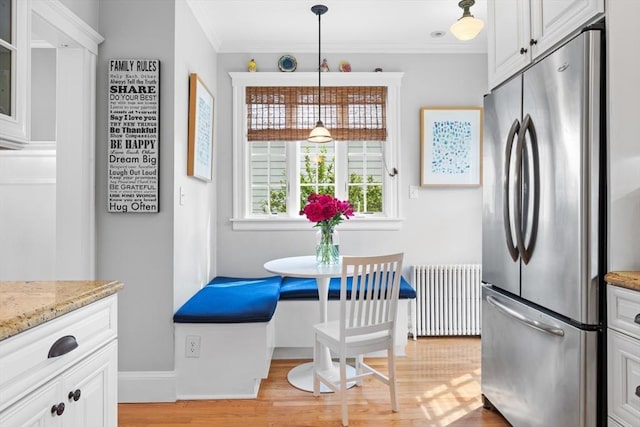 32 Oneida Rd, Winchester, MA 01890 - kitchen featuring freestanding refrigerator, radiator, light wood-type flooring, crown molding, and white cabinetry