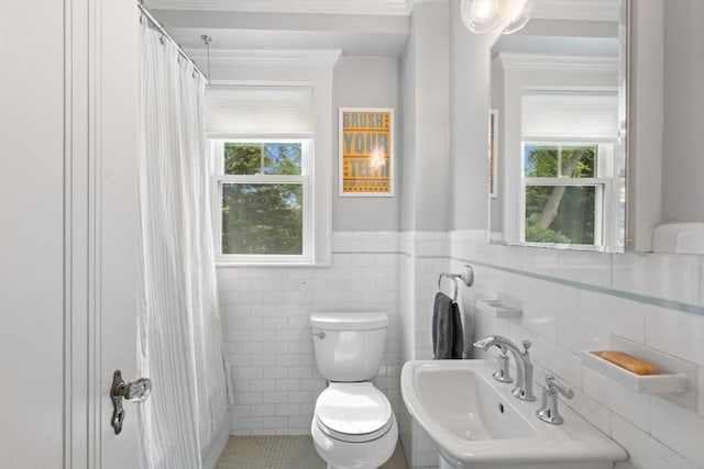32 Oneida Rd, Winchester, MA 01890 - bathroom featuring tile walls, a shower with curtain, ornamental molding, and wainscoting