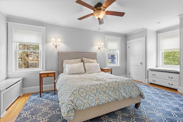 32 Oneida Rd, Winchester, MA 01890 - bedroom with radiator heating unit, wood finished floors, crown molding, and a ceiling fan