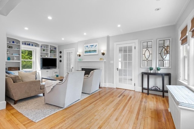 32 Oneida Rd, Winchester, MA 01890 - living room with light wood-style flooring, crown molding, a fireplace, and recessed lighting