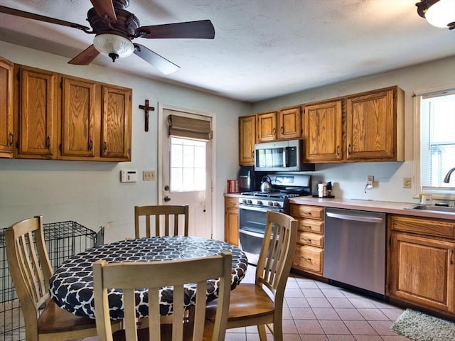 56 Gatehouse Dr, Fall River, MA 02720 - kitchen with appliances with stainless steel finishes, a sink, and brown cabinets