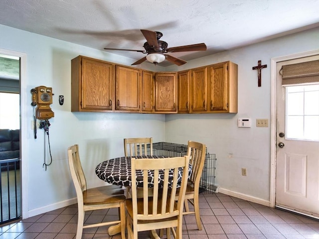56 Gatehouse Dr, Fall River, MA 02720 - dining room featuring tile patterned flooring, ceiling fan, and baseboards