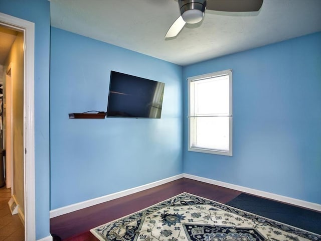 56 Gatehouse Dr, Fall River, MA 02720 - unfurnished bedroom with baseboards, ceiling fan, and dark wood-style flooring