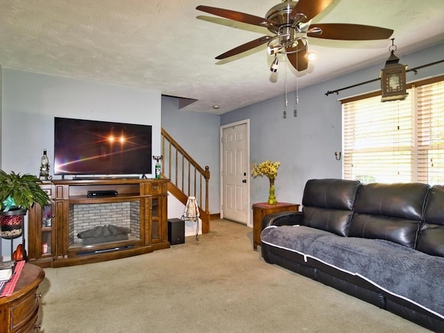 56 Gatehouse Dr, Fall River, MA 02720 - carpeted living area with a ceiling fan, stairs, and a textured ceiling
