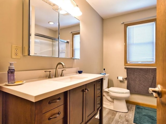 56 Gatehouse Dr, Fall River, MA 02720 - bathroom featuring wood finished floors, a shower with door, vanity, and toilet