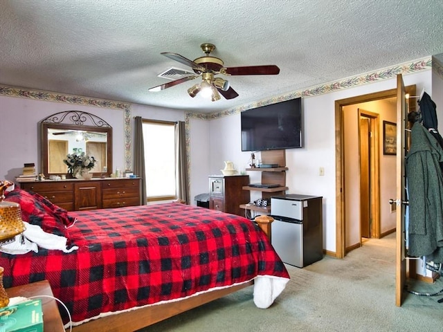56 Gatehouse Dr, Fall River, MA 02720 - bedroom with freestanding refrigerator, light colored carpet, a textured ceiling, and ceiling fan